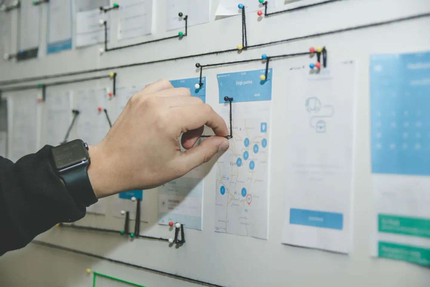 Person arranging a user journey map on a board