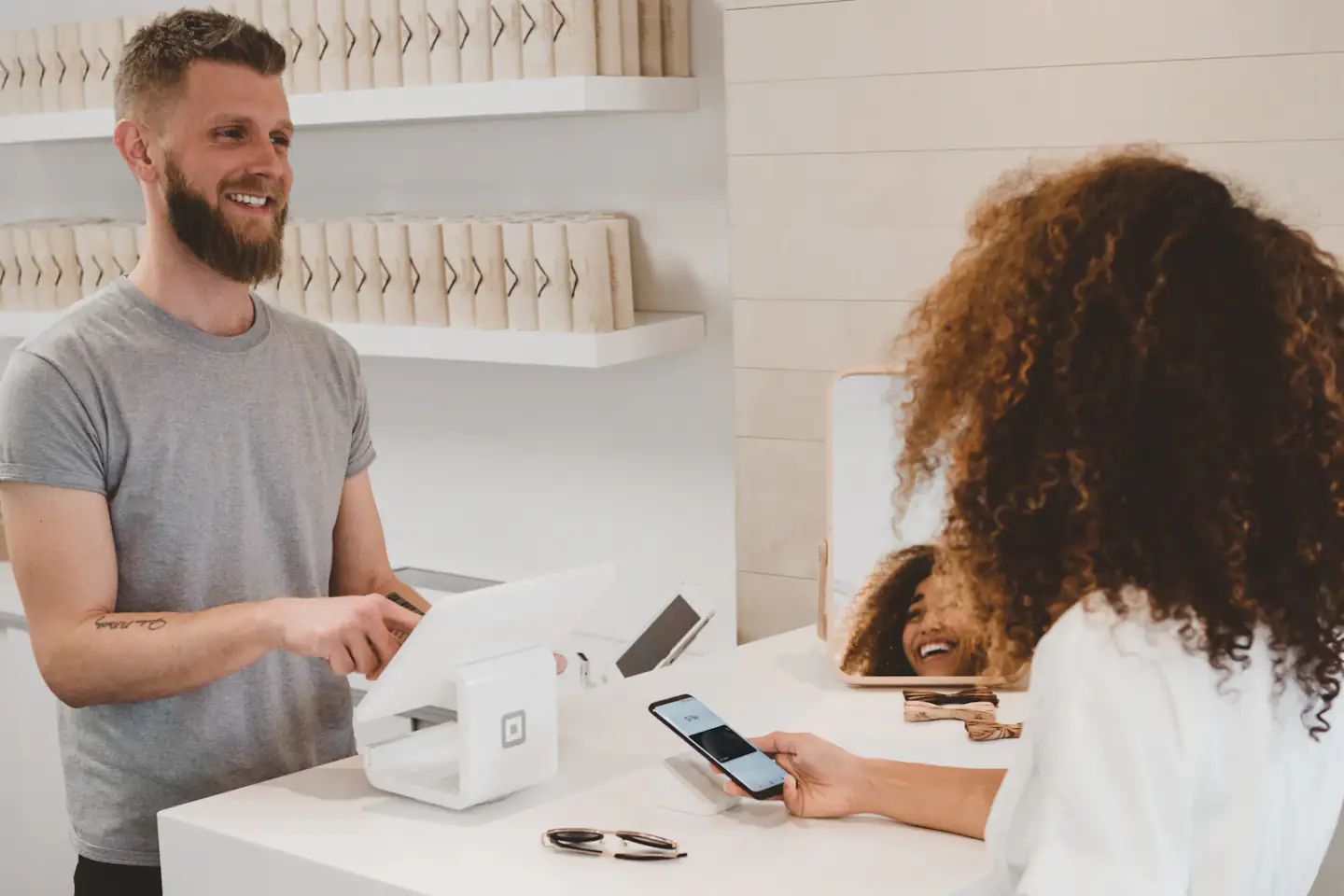 Customer paying with a phone at a retail counter