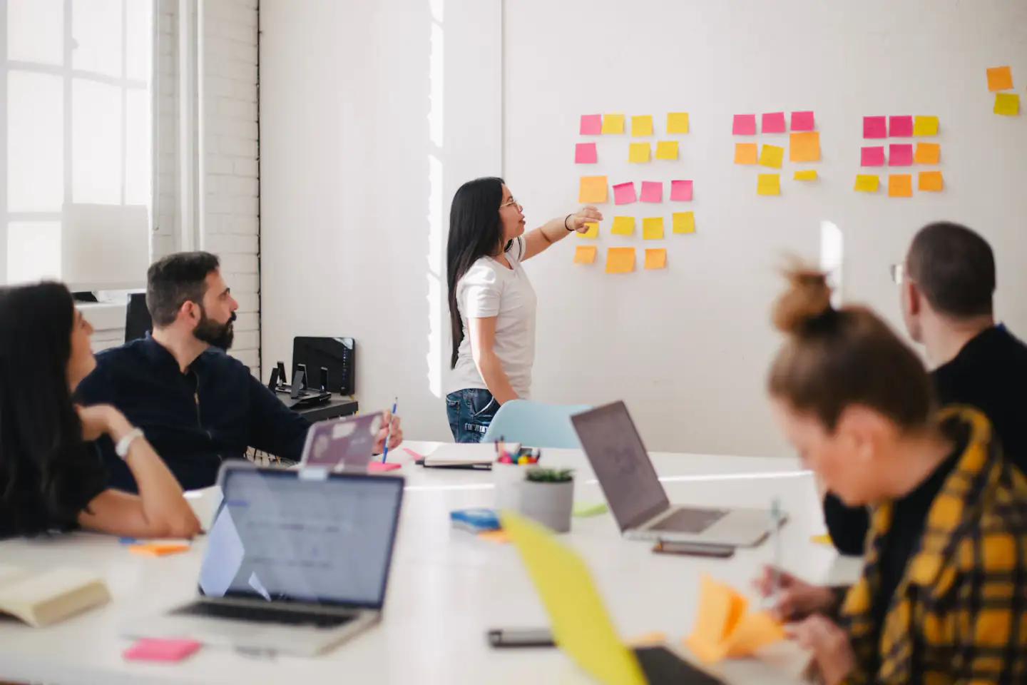 Team workshop with sticky notes on a wall